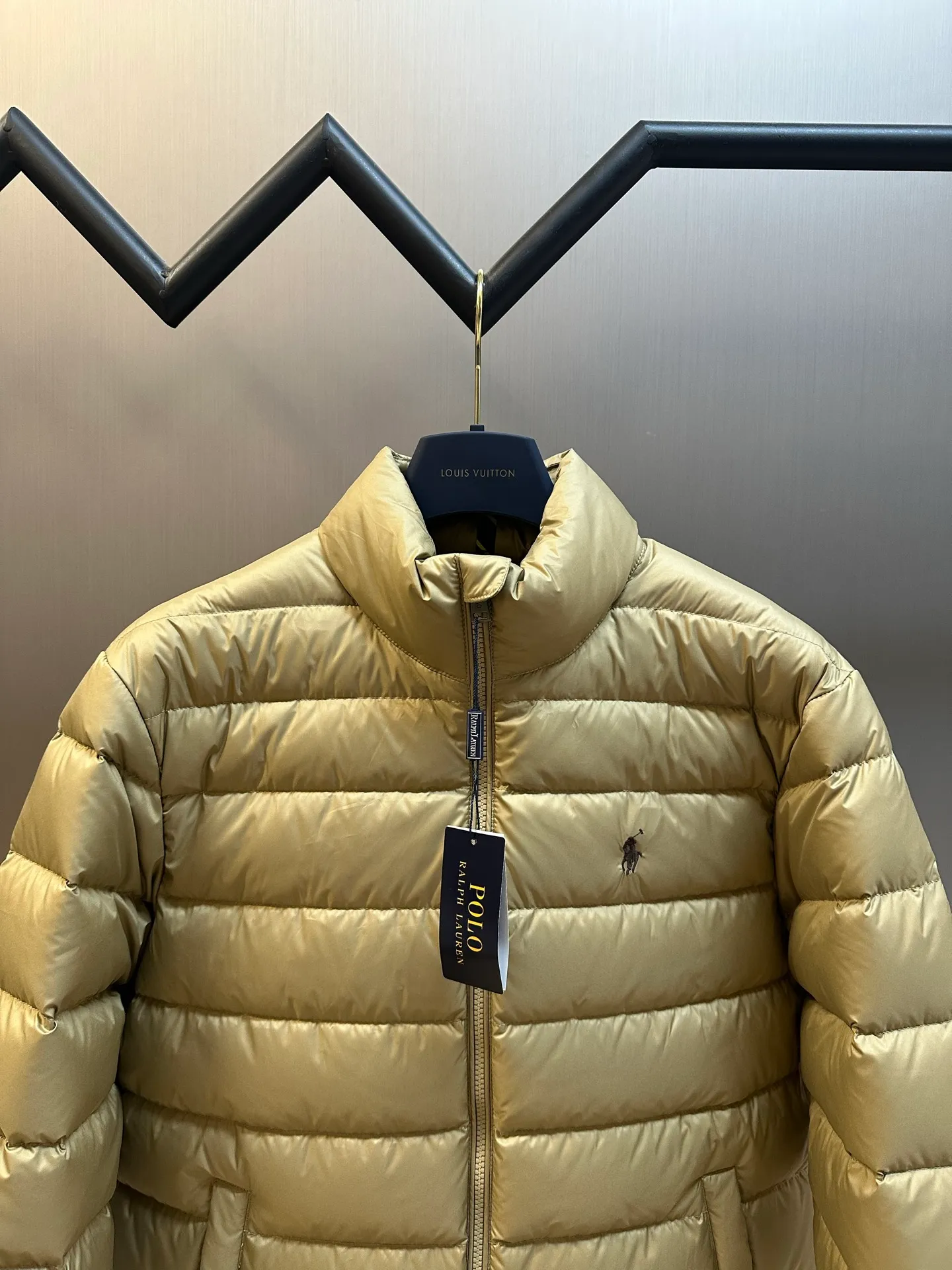 P890 Ralph Lauren lightweight down jacket. The nylon fabric has good windproof and waterproof properties, which can effectively block the intrusion of wind and rain from the outside and keep the inside dry. It is suitable for wearing in humid or rainy environments. The red label on the chest is made with an imported MECLO embroidery machine. The original pattern is scanned first, and then high-quality silk thread is used to make a pattern. The density effect is adjusted by continuous pattern making.  The zipper design is simple and elegant, easy to operate, and the closing design of the cuffs and hem effectively prevents cold wind from invading, improving the warmth and comfort of wearing. It uses 90 white duck down with a weight of 260g to ensure excellent thermal insulation performance. After strict screening and processing, the velvet is not easy to drill, ensuring durability. size: s m l xl